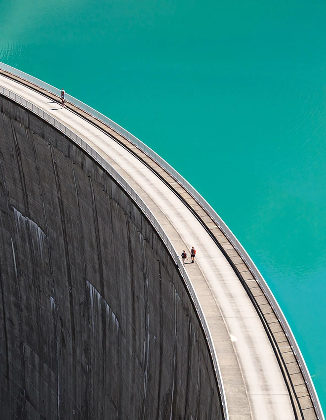 people walking on reservoir dam