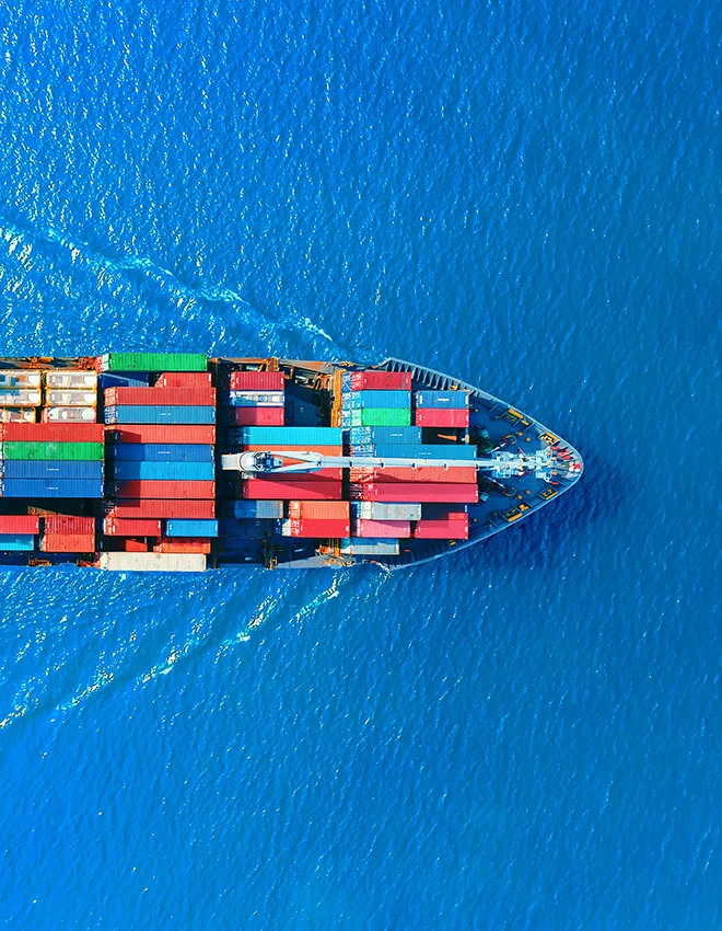 aerial view of colorful container ship in a bright blue sea