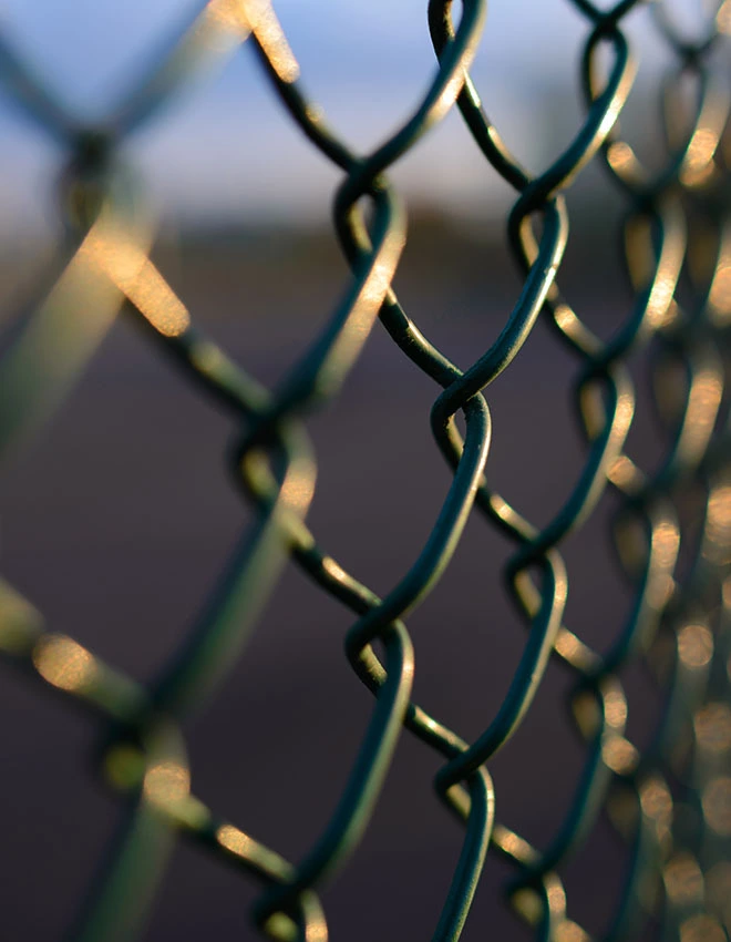 chain link fence with metal grid in perspective, background